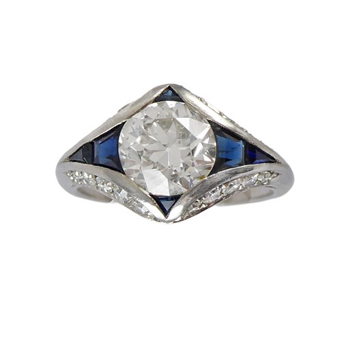 Art Deco diamond and sapphire lozenge cluster ring, c.1920, of geometric design, the central old European cut diamond of 1.80ct M SI2,